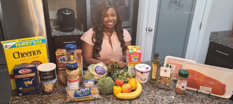 Jamisha Leftwich posing with food items for a news segment