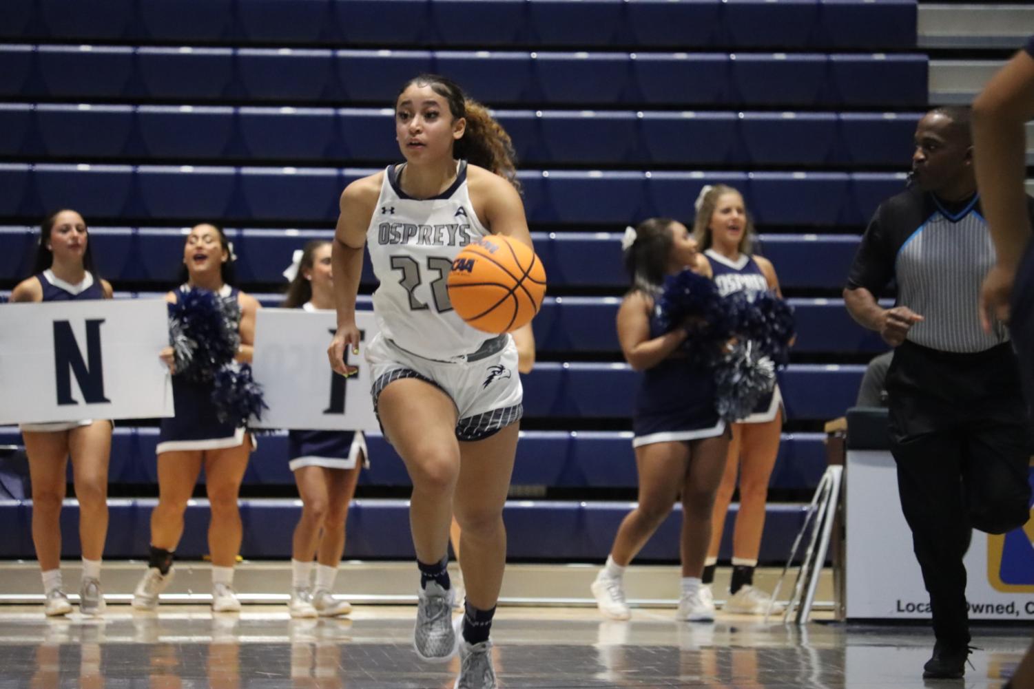 Lyric Swann dribbles the ball up the court