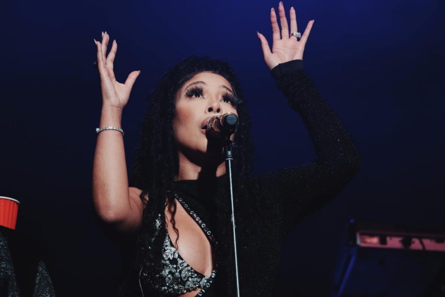 K. Michelle sings with her hands in the air