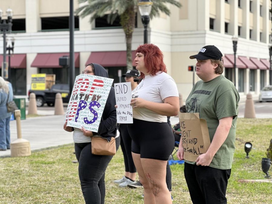 Protesters hold signs