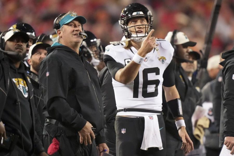 Jacksonville Jaguars quarterback Trevor Lawrence (16) speaks with Jacksonville Jaguars Head Coach Doug Pederson during the second half of an NFL divisional round playoff football game against the Kansas City Chiefs, Saturday, Jan. 21, 2023, in Kansas City, Mo. (AP Photo/Charlie Riedel)