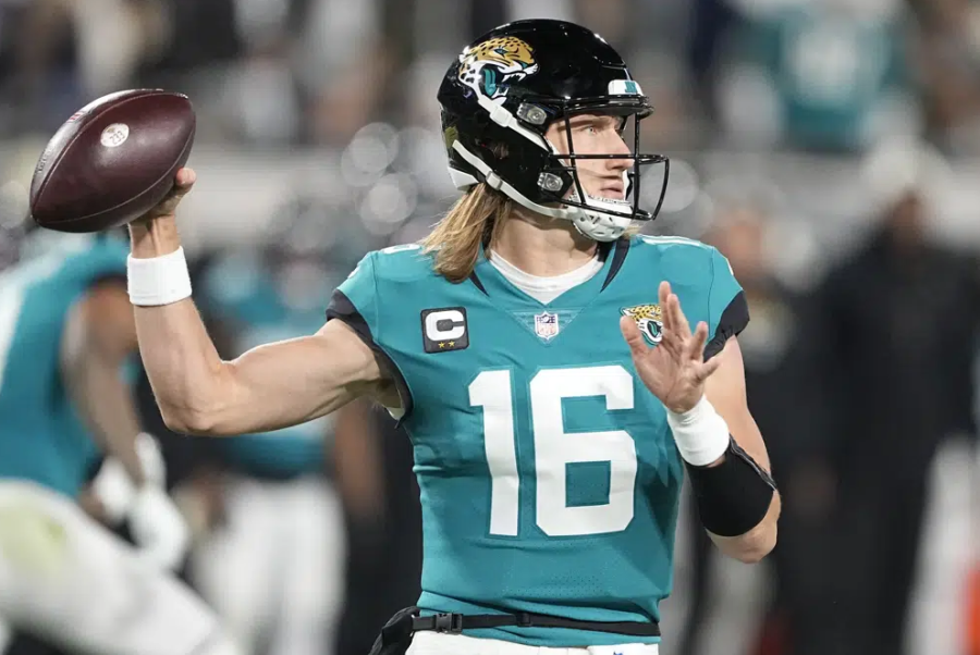 Jacksonville Jaguars quarterback Trevor Lawrence (16) sets back to pass during the first half of an NFL wild-card football game, against the Los Angeles Chargers, Saturday, Jan. 14, 2023, in Jacksonville, Fla. (AP Photo/Chris Carlson)