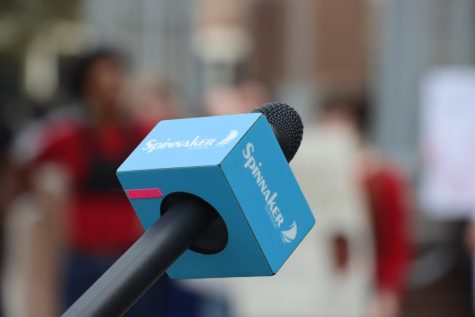 A blue Spinnaker microphone against a blurry background