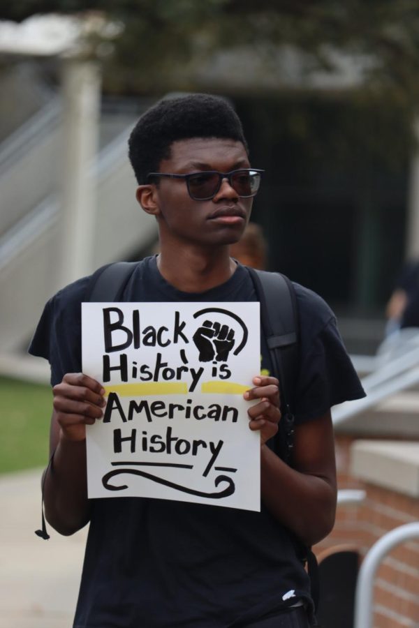 A UNF student holds a sign with the words "Black History is American History" at a rally for diversity in education on Feb. 21, 2023.