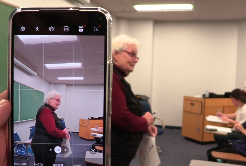 A student records in class with Dr. Rita Brodnaxs approval.