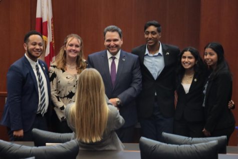 Members of Student Government smile with University of North Florida President Moez Limayem for a photo. 