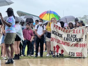 Protesters stood in the rain, continuing chants and speeches regardless of the weather. 