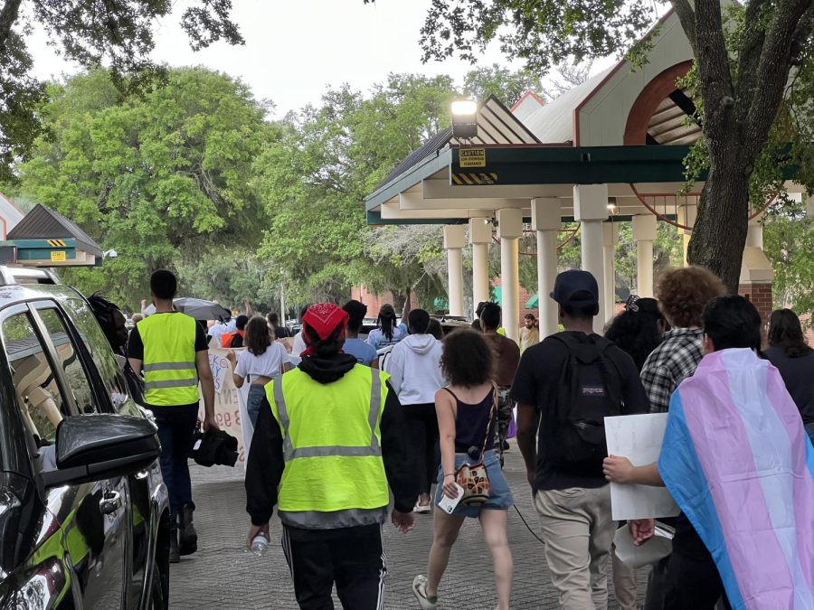 Protesters walk across FAMU's campus on Tuesday.