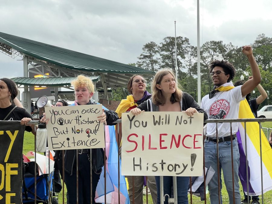 Yelling chants and raising their fists in the air, protesters stand against metal barriers on FAMU's campus Tuesday afternoon. 