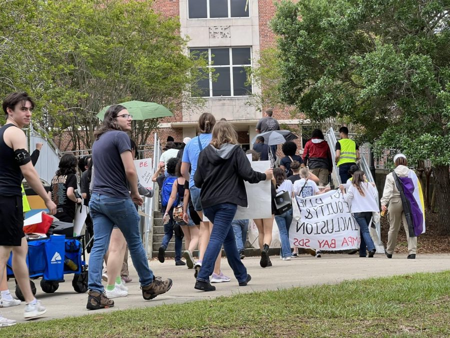 Protesters walk across FAMU's campus on Tuesday.