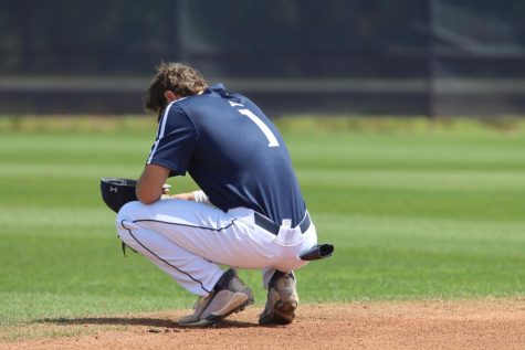 UNF baseball player dejected on the field of play.