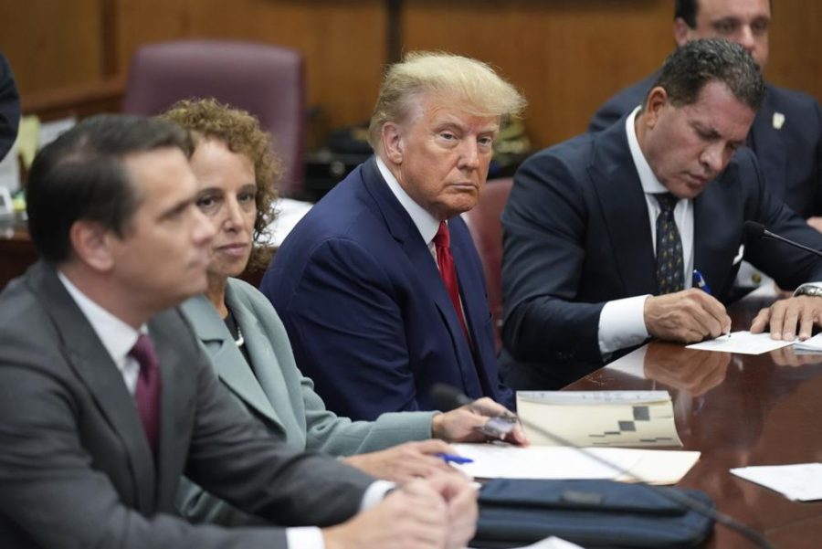 Former President Donald Trump sits at the defense table with his legal team in a Manhattan court, Tuesday, April 4, 2023, in New York. Trump is appearing in court on charges related to falsifying business records in a hush money investigation, the first president ever to be charged with a crime. (AP Photo/Seth Wenig, Pool)