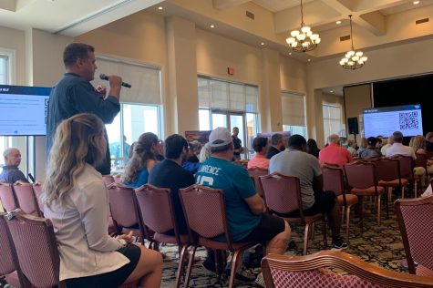 Attendee stands to ask question at Jaguars huddle