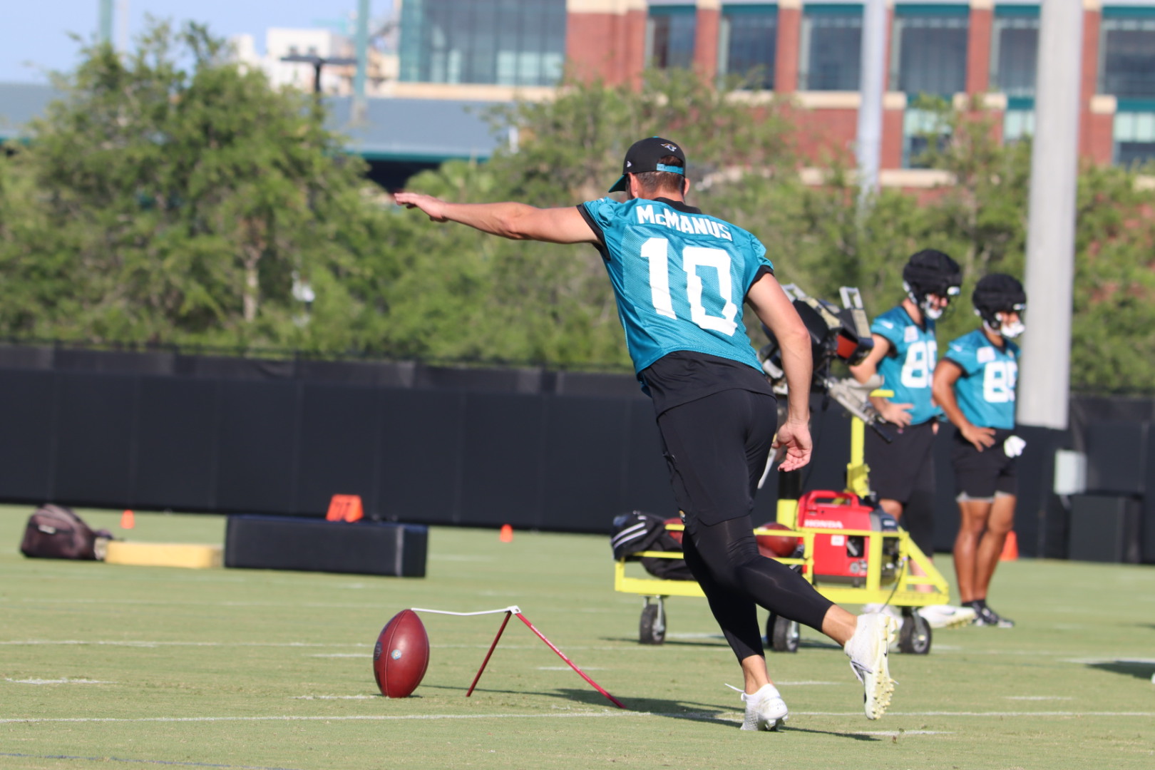 McManus kicks the football