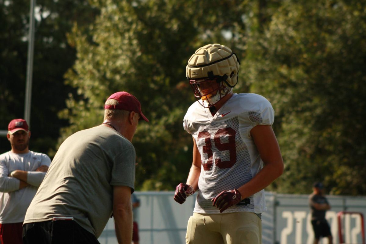 Coach explaining concept to player.