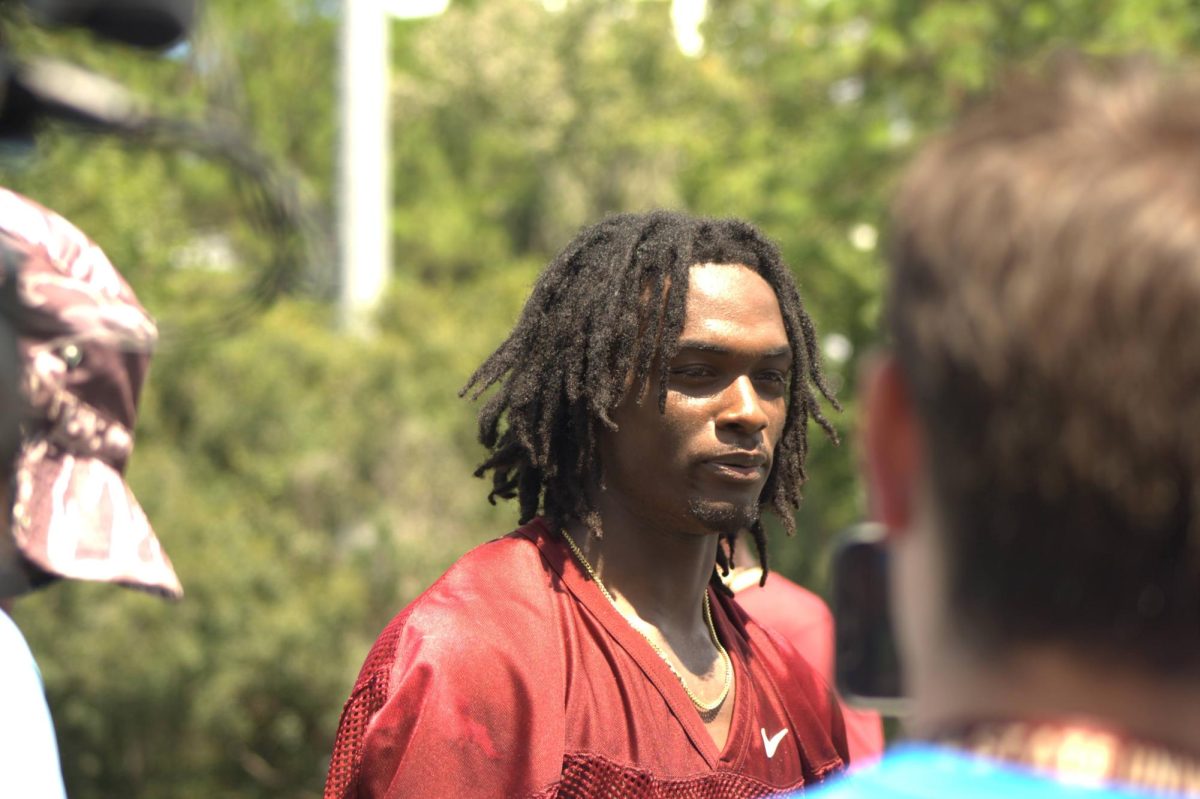 Akeem Dent speaks with the media.