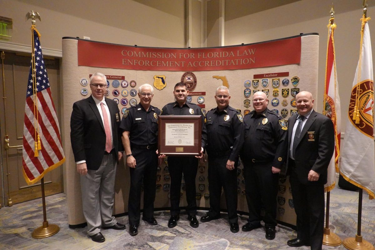 UPD Chief Frank Mackesy (second from left) and other university officers accept the Excelsior status from the Commission for Florida Law Enforcement Accreditation. (Photo courtesy of UPD)