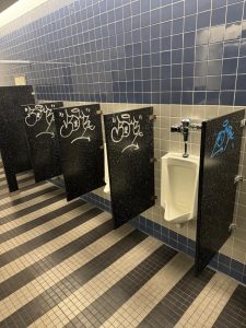 Blue and silver graffiti has been found in mens bathrooms 10 times this semester. (Photos courtesy of UPD Chief Frank Mackesy)