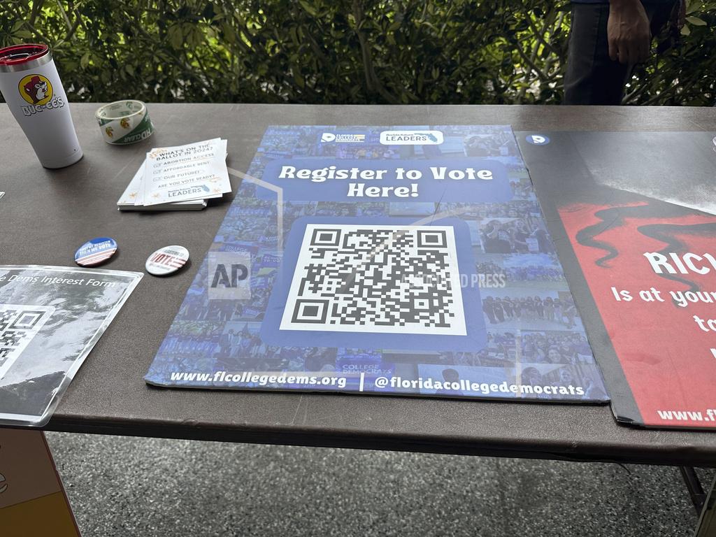 A QR code sign is displayed at Florida Atlantic University on Thursday, April 11, 2024, in Boca Raton, Fla. for students to register to vote. Abortion and marijuana will be on Floridas November ballot, and these issues are critical issues for young voters. (AP Photo/Cody Jackson)