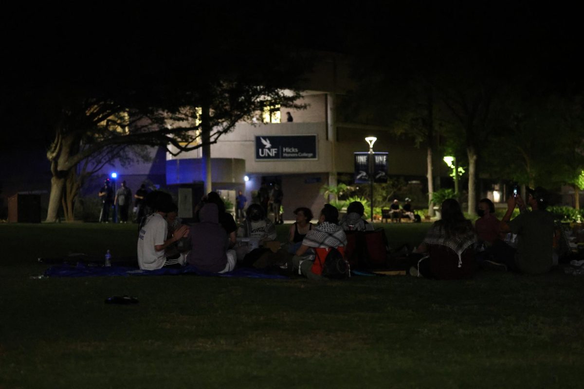 Student protesters sit on the Green past the 10 p.m. curfew installed by police. 
