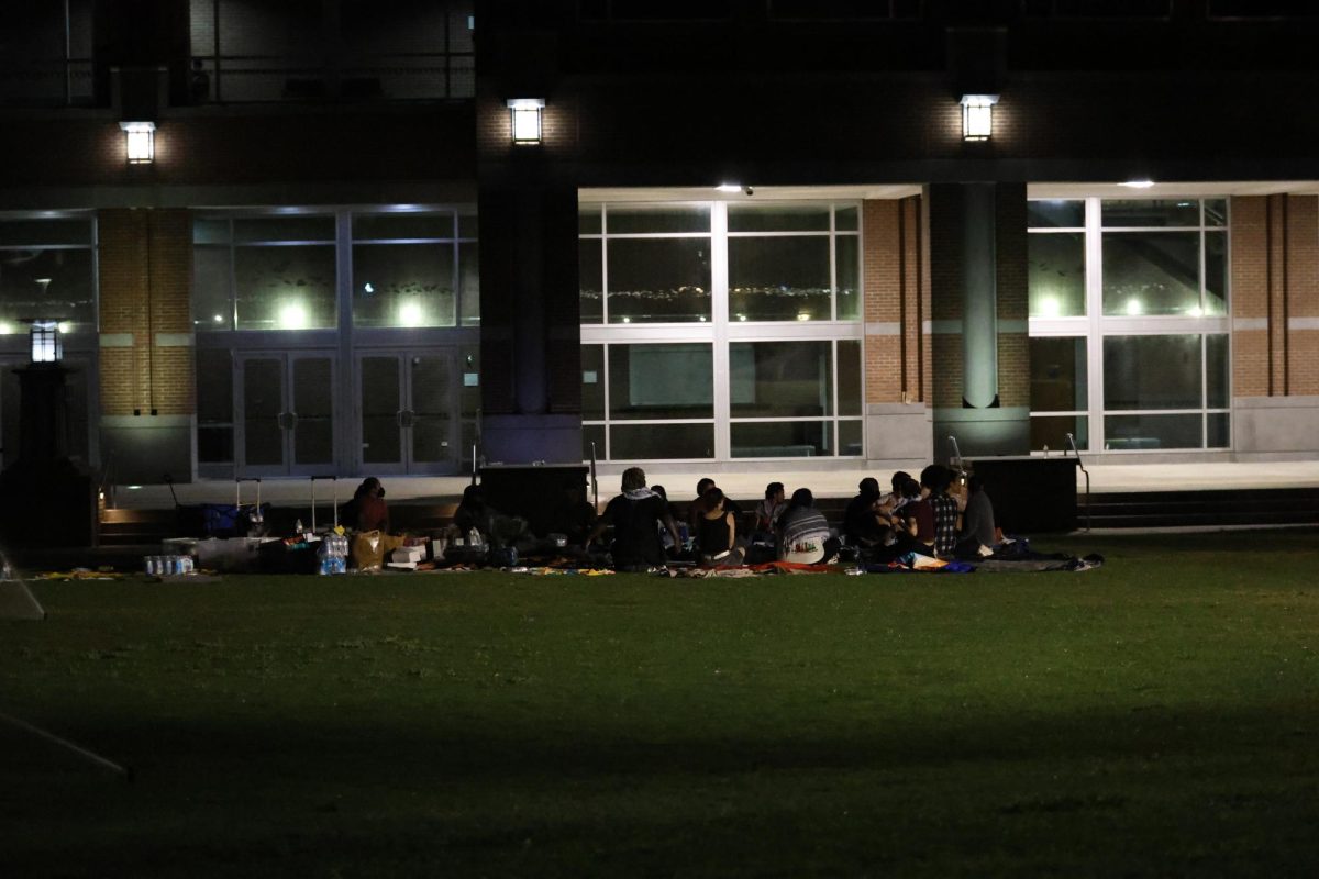 Student protesters sit on the Green past the 10 p.m. curfew installed by police. 
