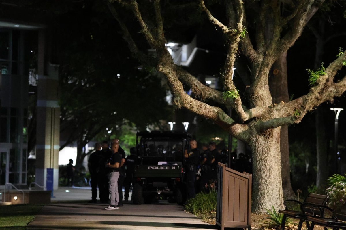 Officers in riot gear arrived to assist. They stood off to the side before marching onto the Green. 