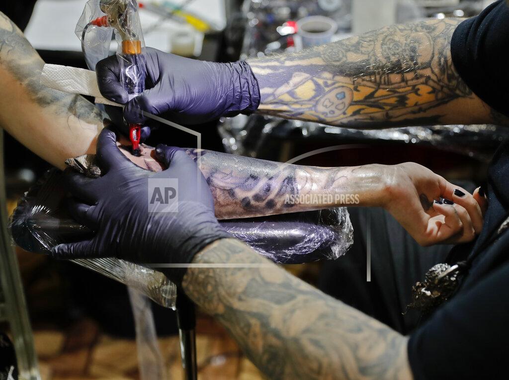 Tattoo artist Paul Booth of the United States works during the International Tattoo Convention Bucharest 2016 in Bucharest, Romania, Sunday, Oct. 16, 2016. Prominent tattoo artists from across the world displayed their skills in the Romanian capital over the weekend.(AP Photo/Vadim Ghirda)