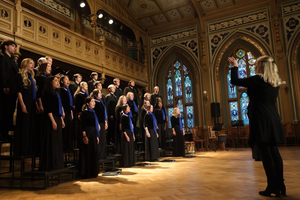 Cara Tasher conducts the UNF chamber ensemble at the Small Guild Hall in Riga, Latvia. In Riga, the chamber singers performed with the BALSIS Youth Choir.