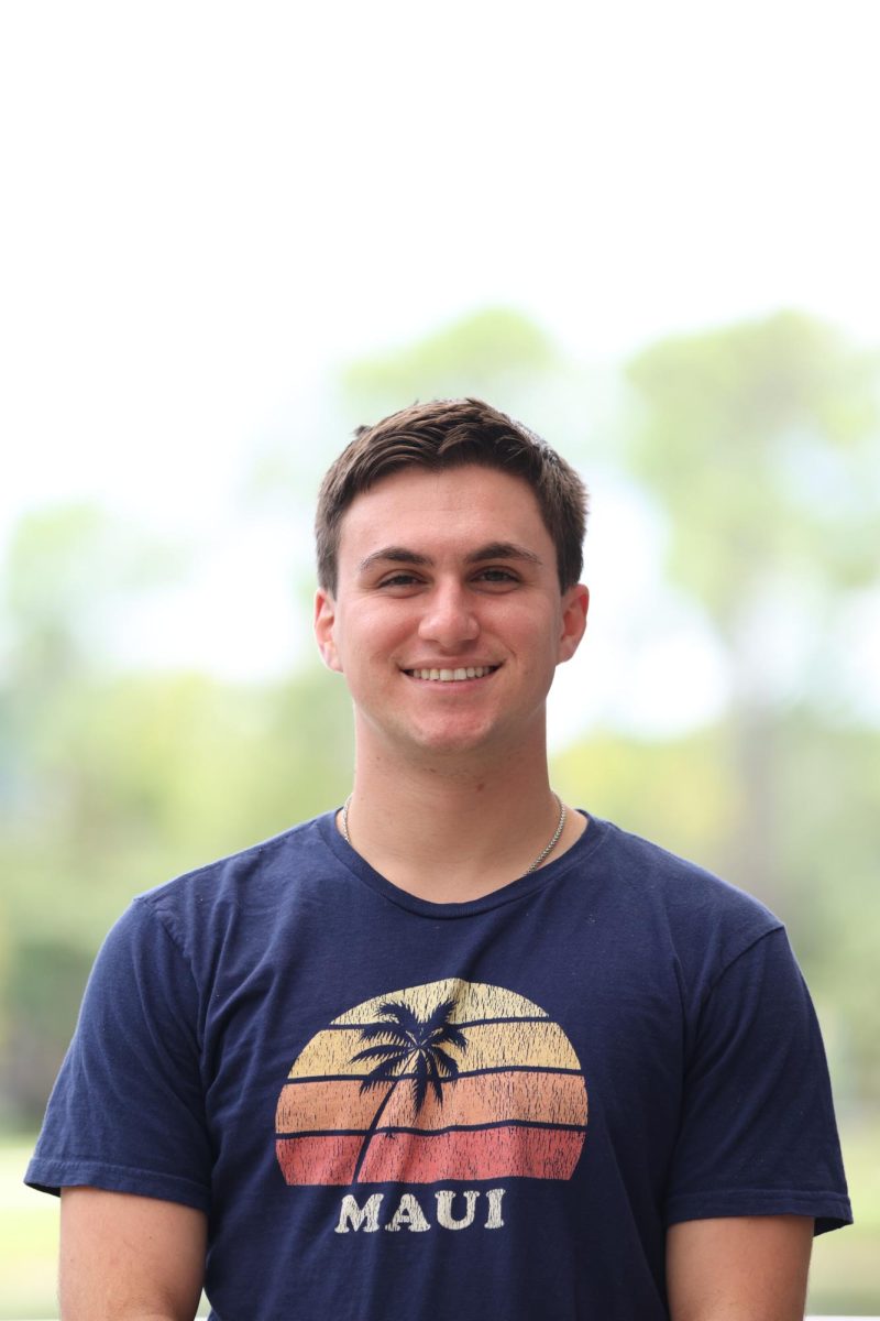 young man in a Maui shirt smiles