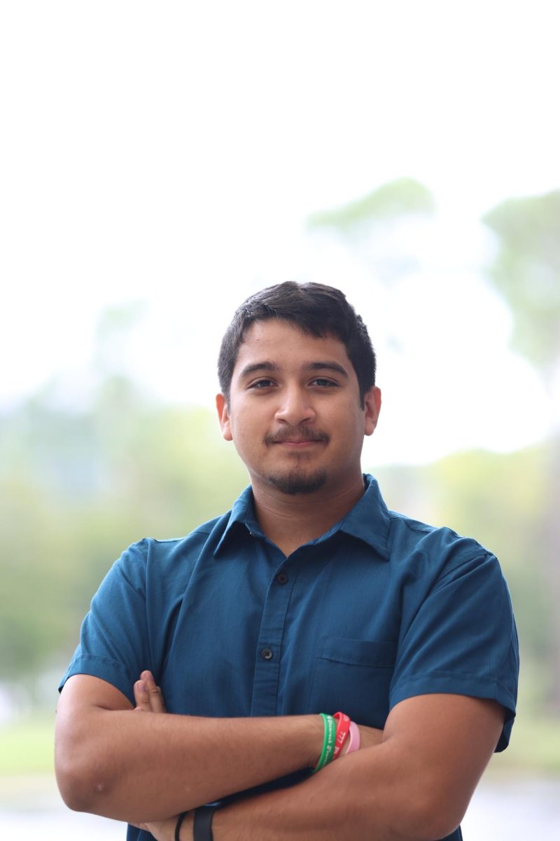 young man in blue shirt strikes a fierce pose