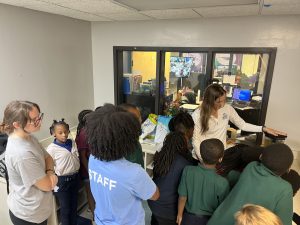 Students from Richard Lewis Brown Elementary watch as a volunteer student from UNF demonstrates blending a nutritious smoothie to the class. (Courtesy of Dr. Jamie Marchio)