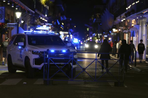 A barrier and police car block off a road after a vehicle drove into a crowd on New Orleans' Canal and Bourbon streets on New Years Eve.