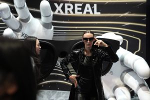 A model wears Xreal augmented reality glasses are modeled at a booth during the CES tech show, Wednesday, Jan. 8, 2025, in Las Vegas. (AP Photo/John Locher)