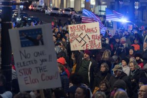 People protest during a rally against Elon Musk outside the Treasury Department in Washington, Tuesday, Feb. 4, 2025. (AP Photo/Jose Luis Magana)