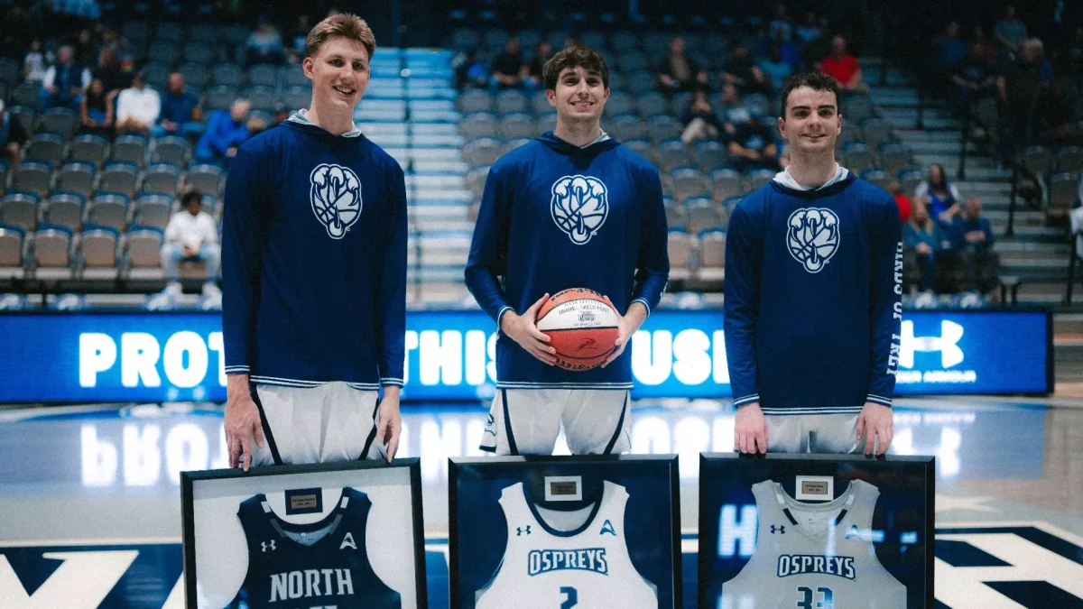 (left to right) Seniors Nestor Dyachok, Nate Lliteras, and Oscar Berry receive framed jerseys before their final home game. (Courtesy of UNF Athletics)