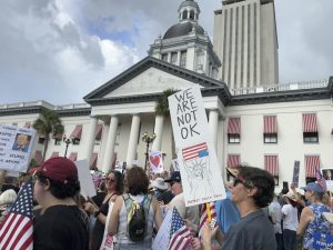 People gather on the grounds of Florida’s old capitol in Tallahassee, Fla., for “No Kings” protest