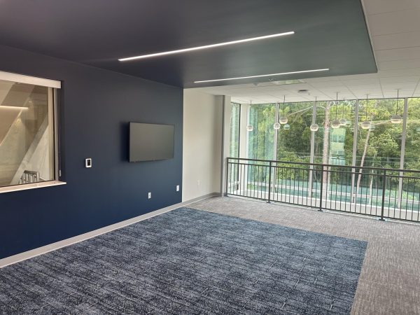 The common area lounge in the new UNF honors dorm with blue painted walls and big windows