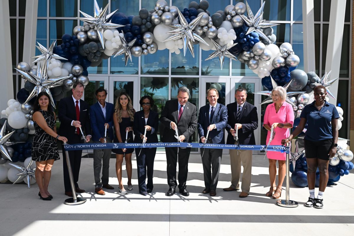 UNF President Moez Limayem, some university trustees, administrators,  a city councilman and other community members during a ribbon cutting event for Osprey Ridge.