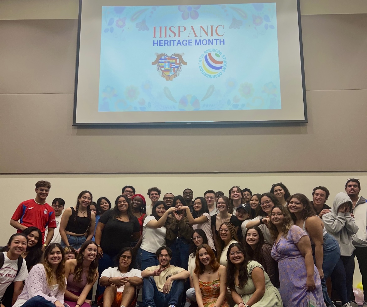 Members of UNF LASO pose for a photo together inside a meeting room.