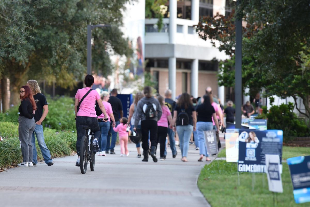 Lisa Ford, Hunter Ford's mother, ride her bike around campus during Saturday's memorial.