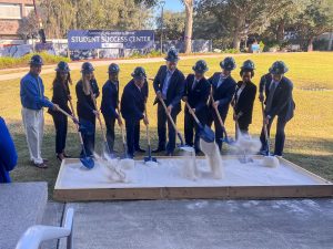 Trustees and community partners pose to mark the groundbreaking of a Student Success Center.