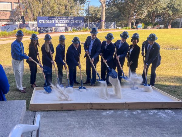 Trustees and community partners pose to mark the groundbreaking of a Student Success Center.