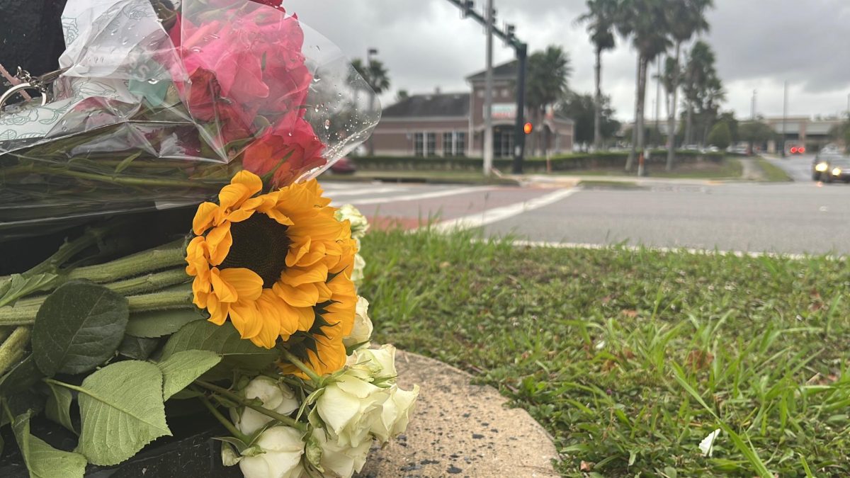 Flowers sit near the site of the motorcycle accident that occurred near UNF campus
