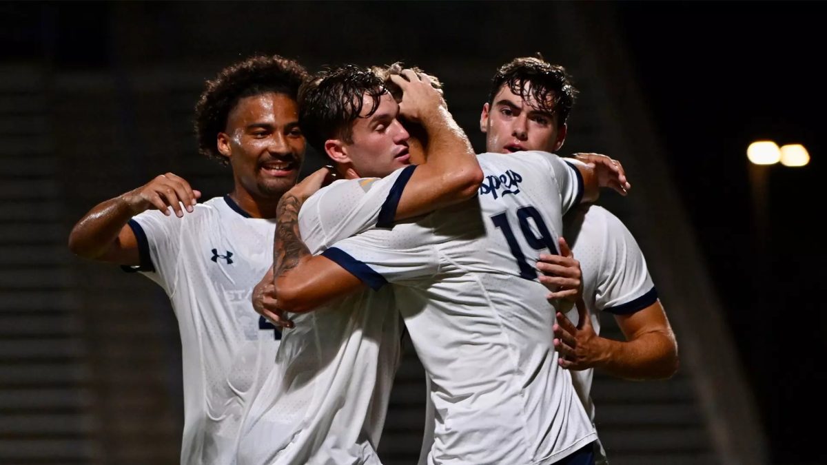 Jaxon Reinhardt celebrates with his teammates during a UNF men's soccer game. (Courtesy of UNF Athletics)