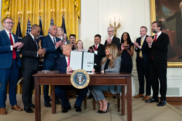 Serenity Miller stands behind President Donald Trump and first lady Melania Trump during the signing of the executive order.