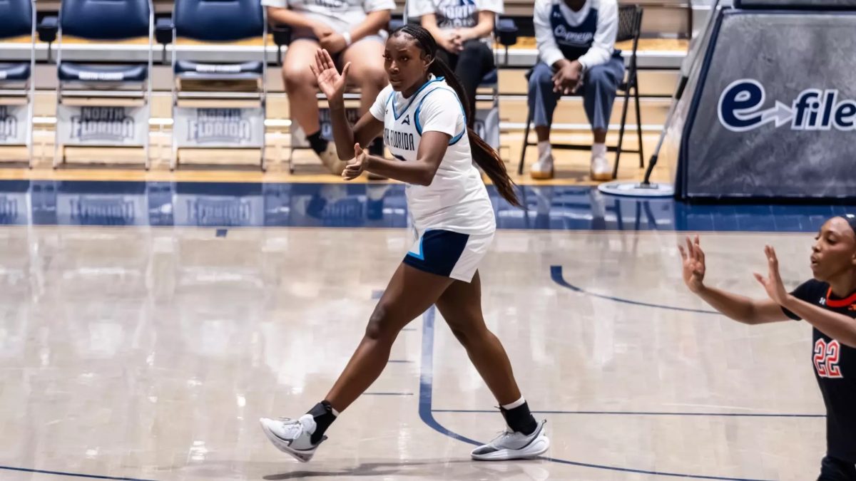 Dezuray McGill cheering on her team as they win the game against Campbell with a buzzer beater by Alonya Waldon