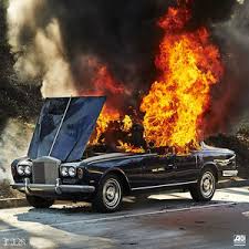 Back car with hood open and large flames coming from the cab