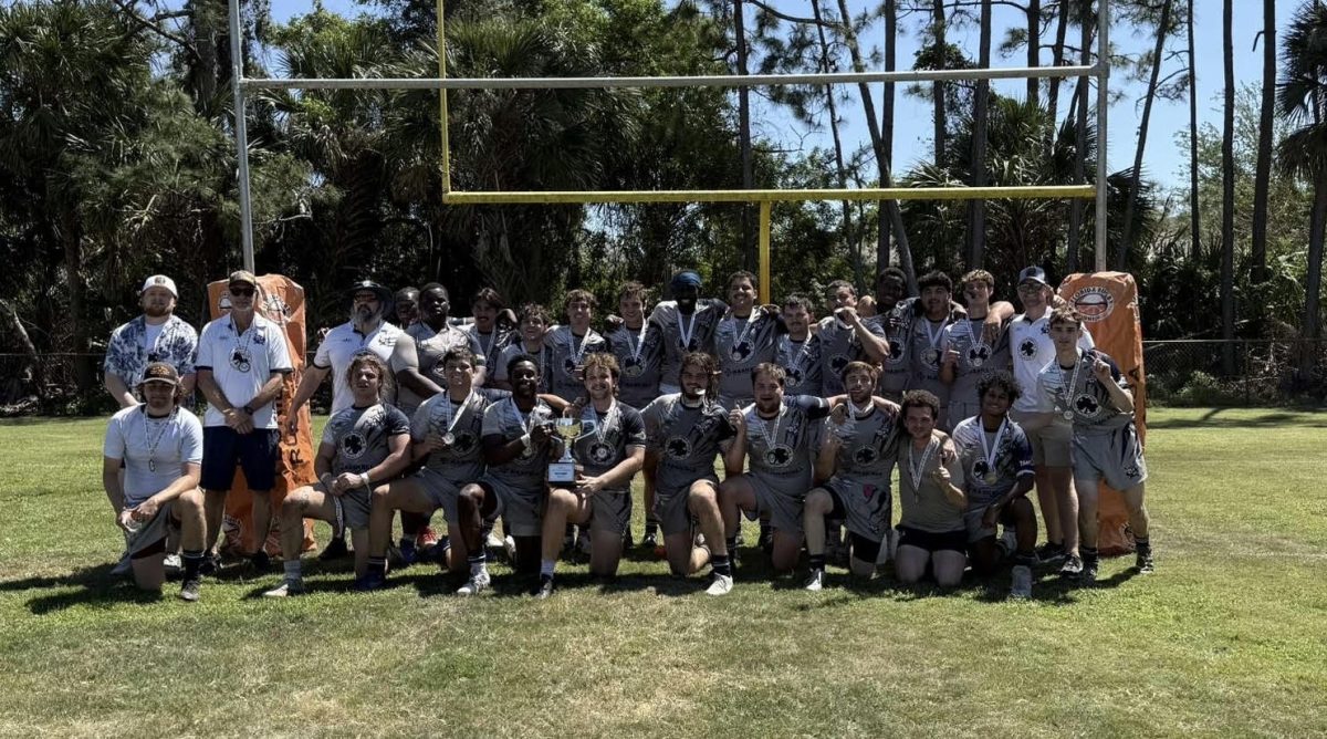 Rugby team lined up on the field.