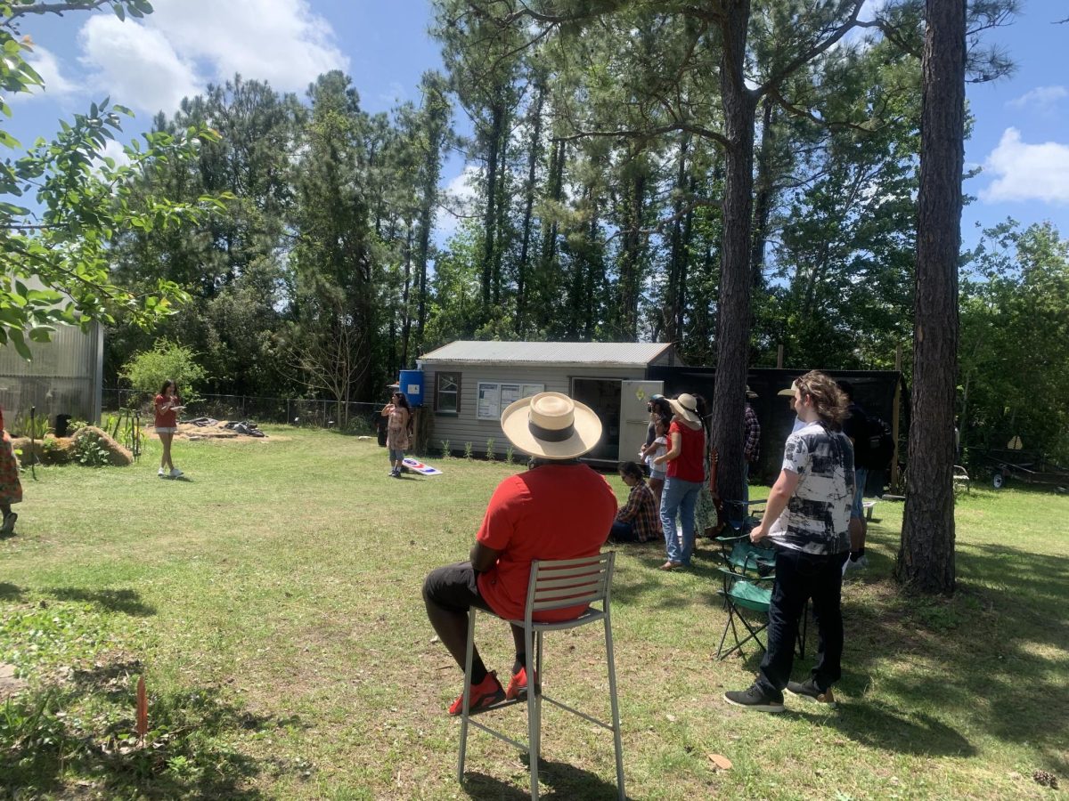 Group stands in circle outside.