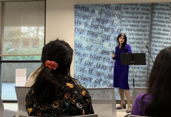 Woman standing at podium in front of students.